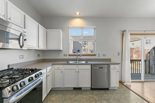 a kitchen with stainless steel appliances granite countertop a stove and a sink