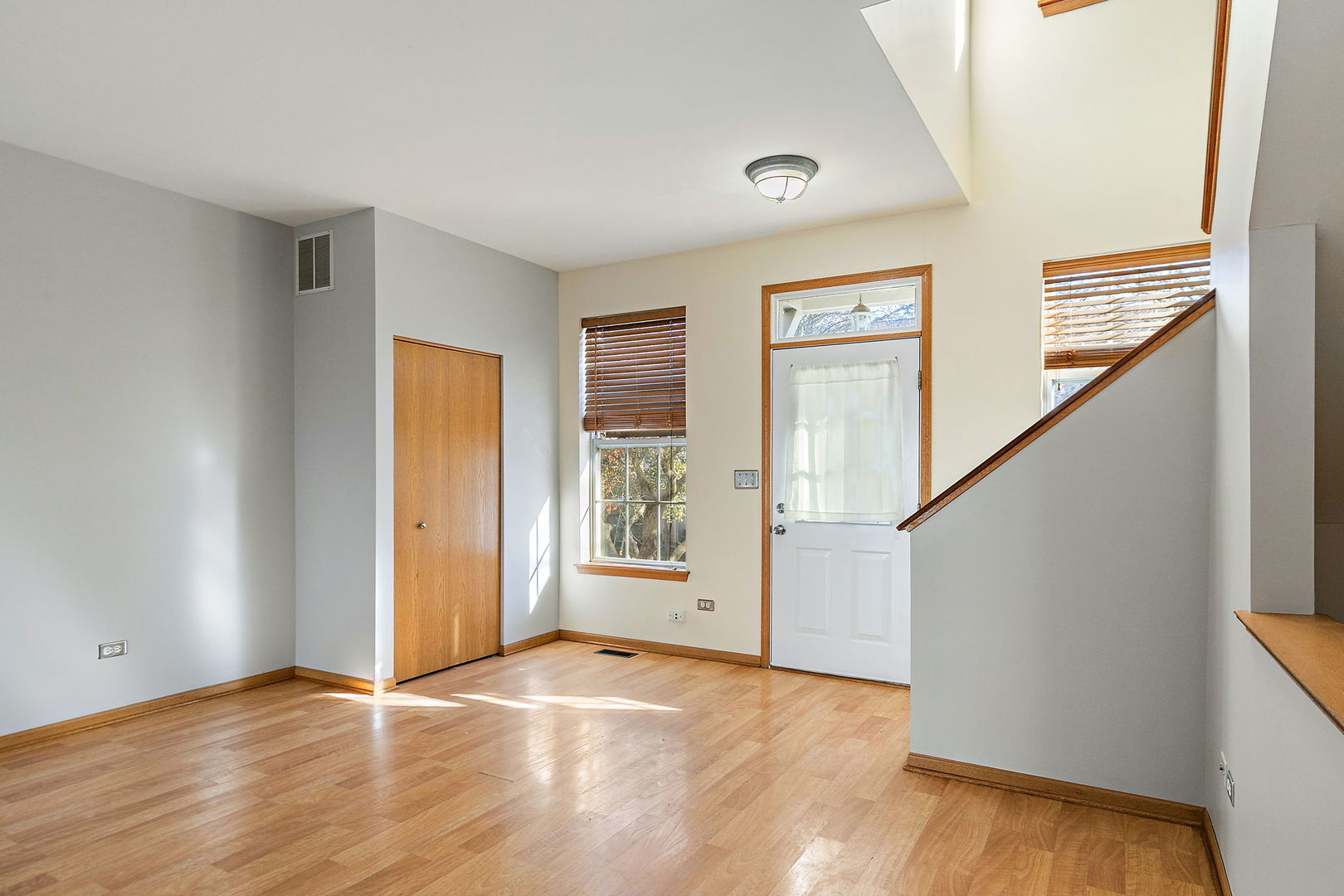 614 Littleton Trail, Unit 614 Elgin, IL 60120 - Photo 6 of 30 a view of an empty room with wooden floor and a window