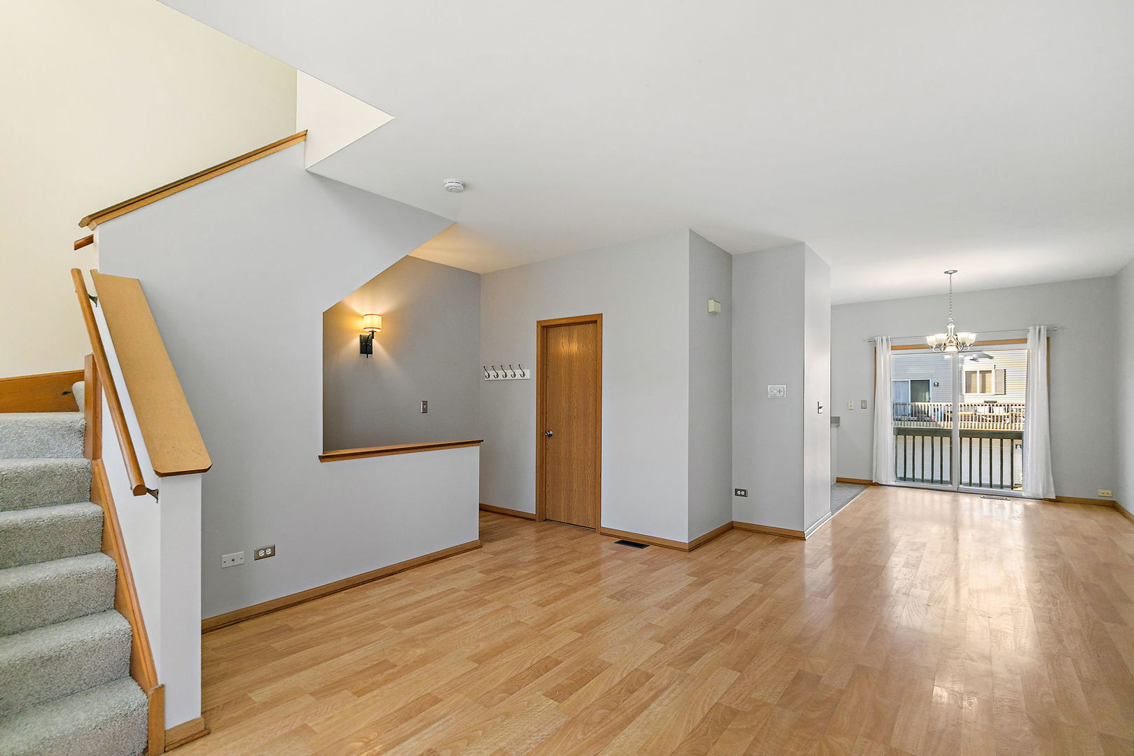 614 Littleton Trail, Unit 614 Elgin, IL 60120 - Photo 10 of 30 a view of a livingroom with wooden floor and stairs