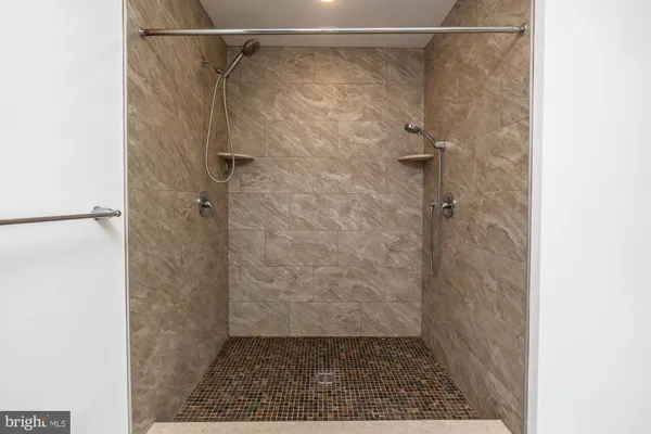 an empty room with wooden floor a ceiling fan and closet