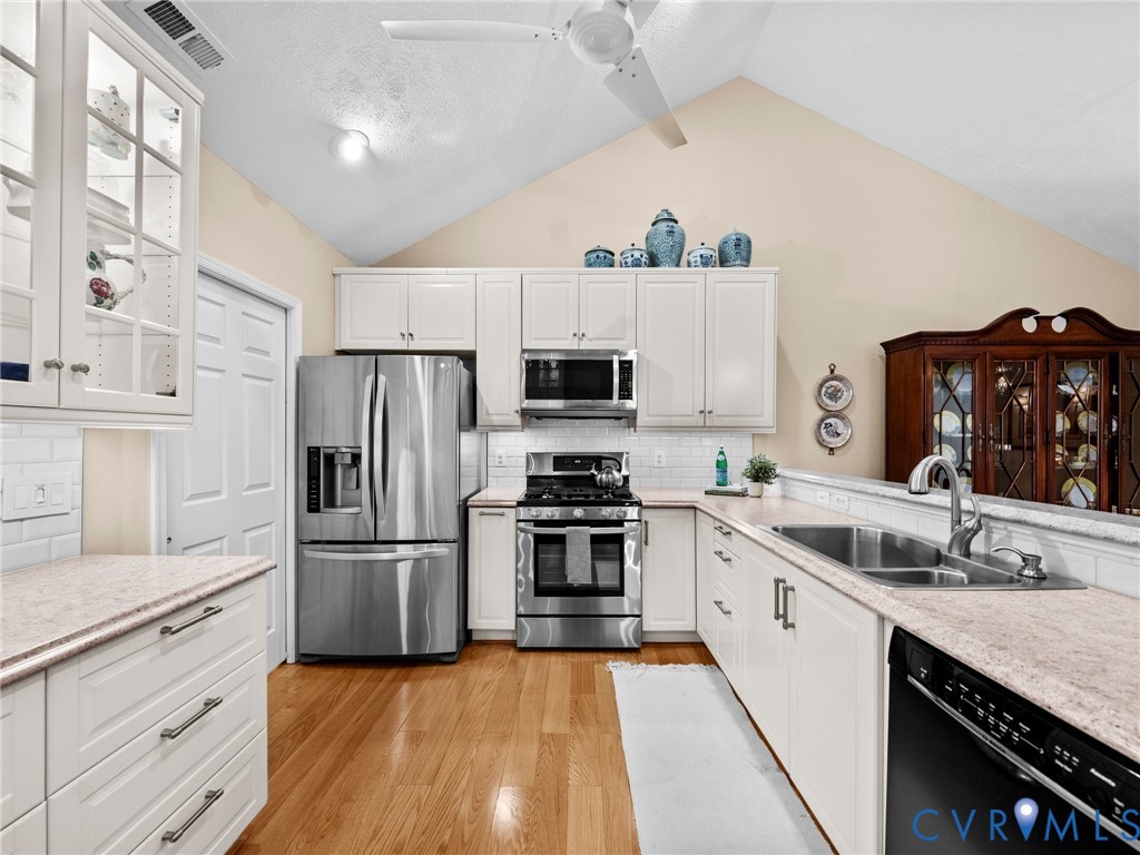 1338 Tannery Circle Midlothian, VA 23113 - Photo 19 of 37 a kitchen with a sink stove and refrigerator