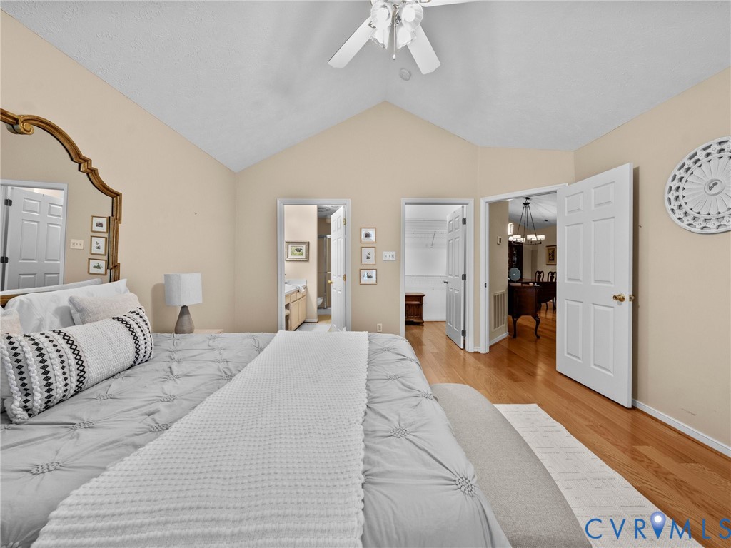 1338 Tannery Circle Midlothian, VA 23113 - Photo 26 of 37 a spacious bedroom with a large bed and a chandelier