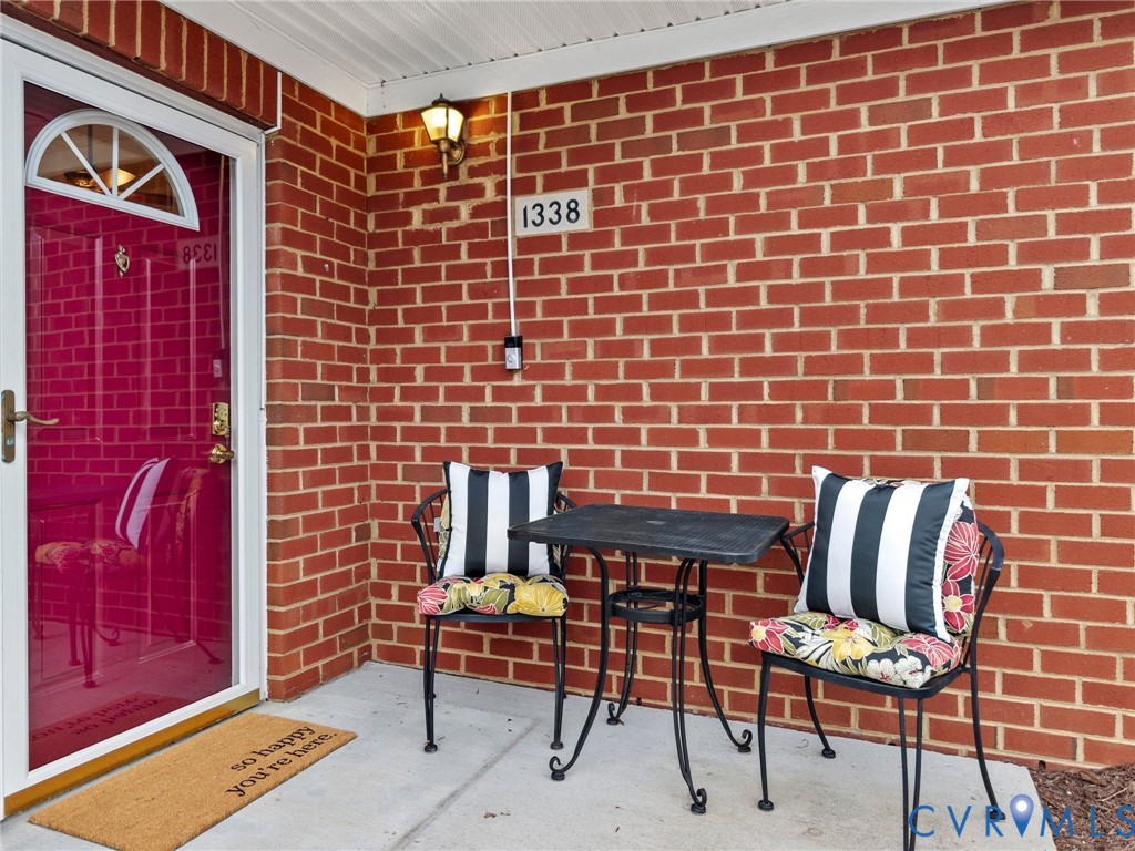 1338 Tannery Circle Midlothian, VA 23113 - Photo 4 of 37 a view of a brick wall with two chairs in a patio