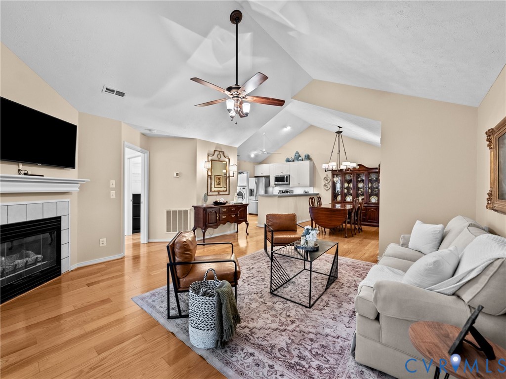 1338 Tannery Circle Midlothian, VA 23113 - Photo 7 of 37 a living room with furniture a fireplace and a flat screen tv