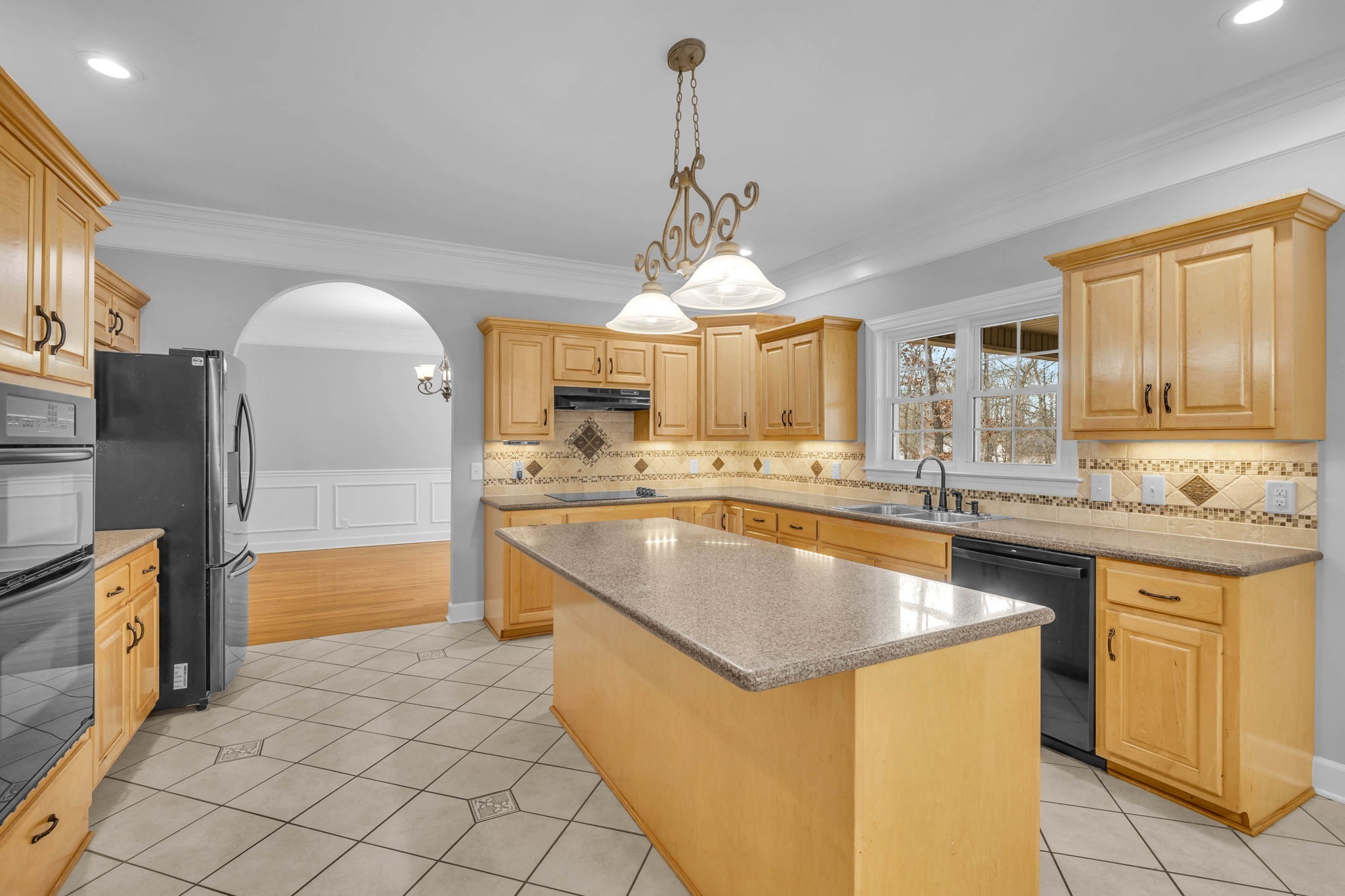 1273 Cedar Grove Road Lebanon, TN 37087 - Photo 14 of 52 a large kitchen with kitchen island granite countertop a sink and a refrigerator