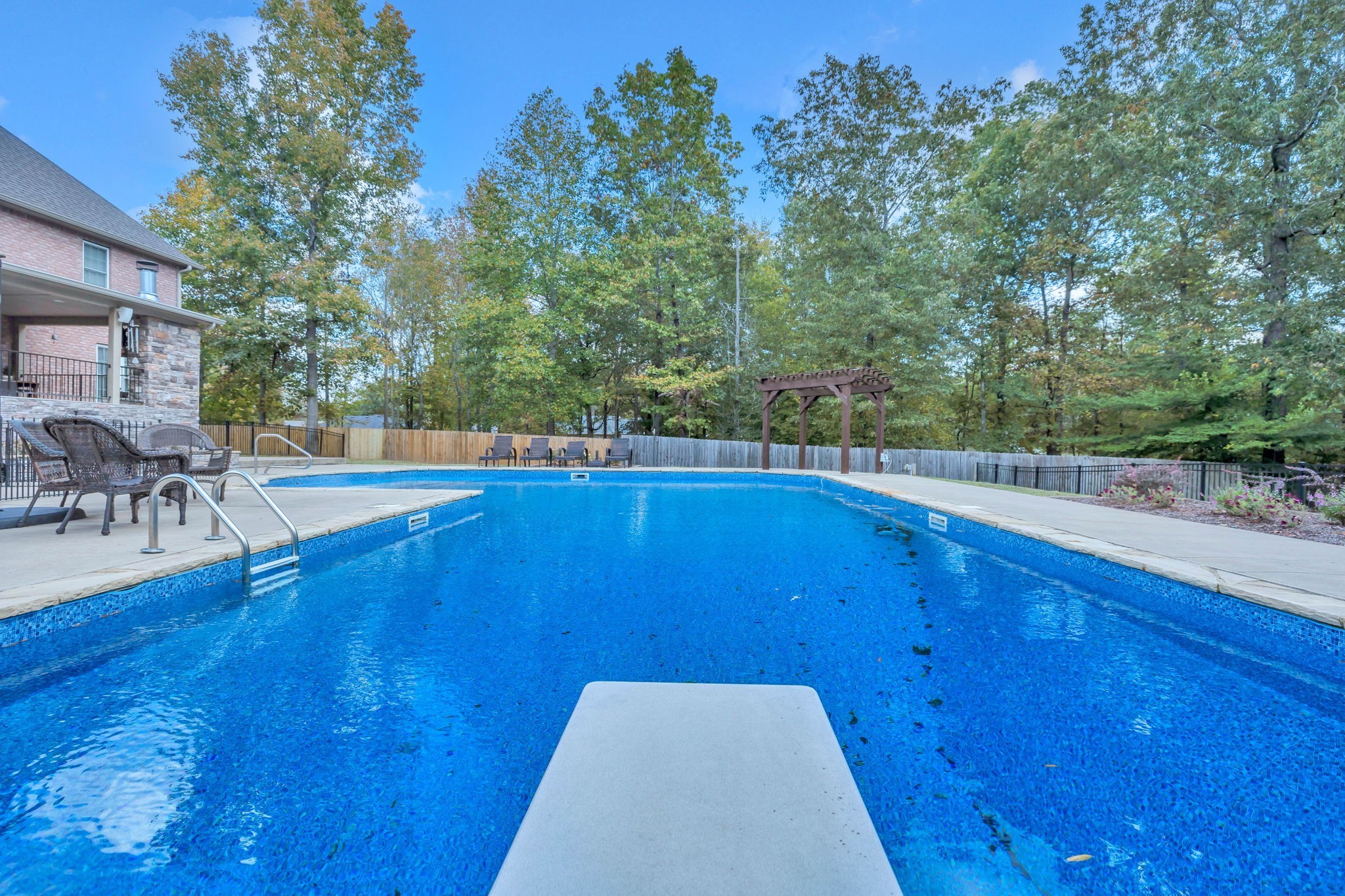 1273 Cedar Grove Road Lebanon, TN 37087 - Photo 42 of 52 a view of a swimming pool with lawn chairs under an umbrella