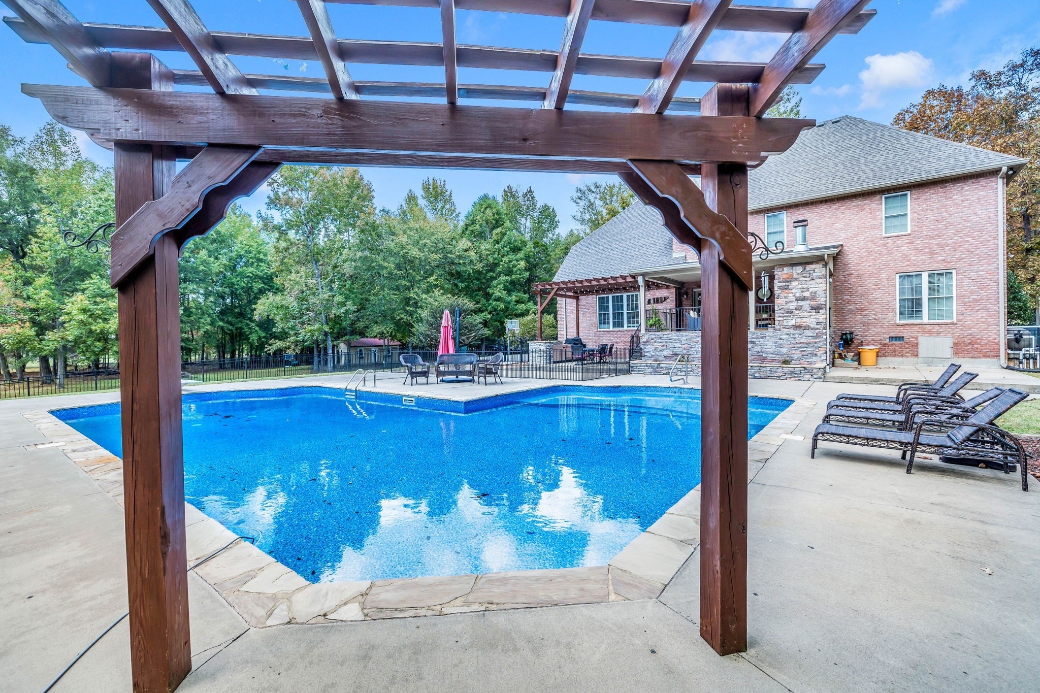 1273 Cedar Grove Road Lebanon, TN 37087 - Photo 45 of 52 a view of a patio with a table and chairs under an umbrella with a small yard