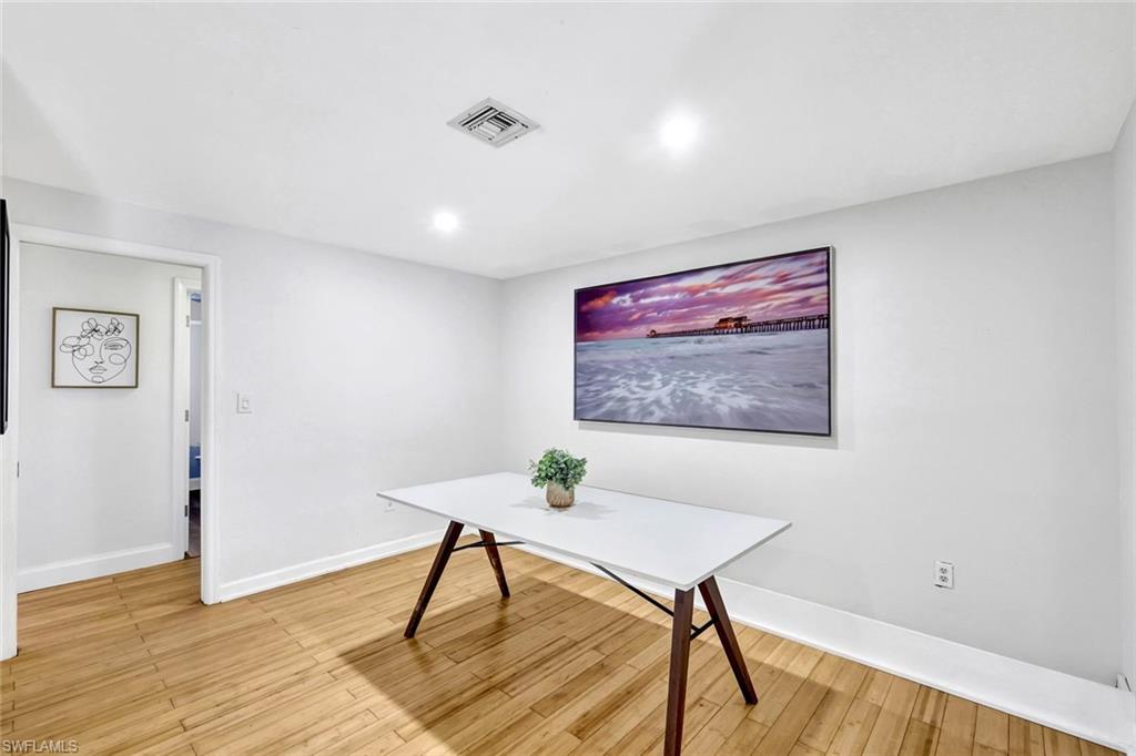 237 Burning Tree Drive Naples, FL 34105 - Photo 11 of 26 a view of a livingroom with furniture and wooden floor