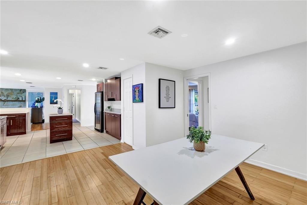 237 Burning Tree Drive Naples, FL 34105 - Photo 12 of 26 a living room with furniture potted plant and a flat screen tv