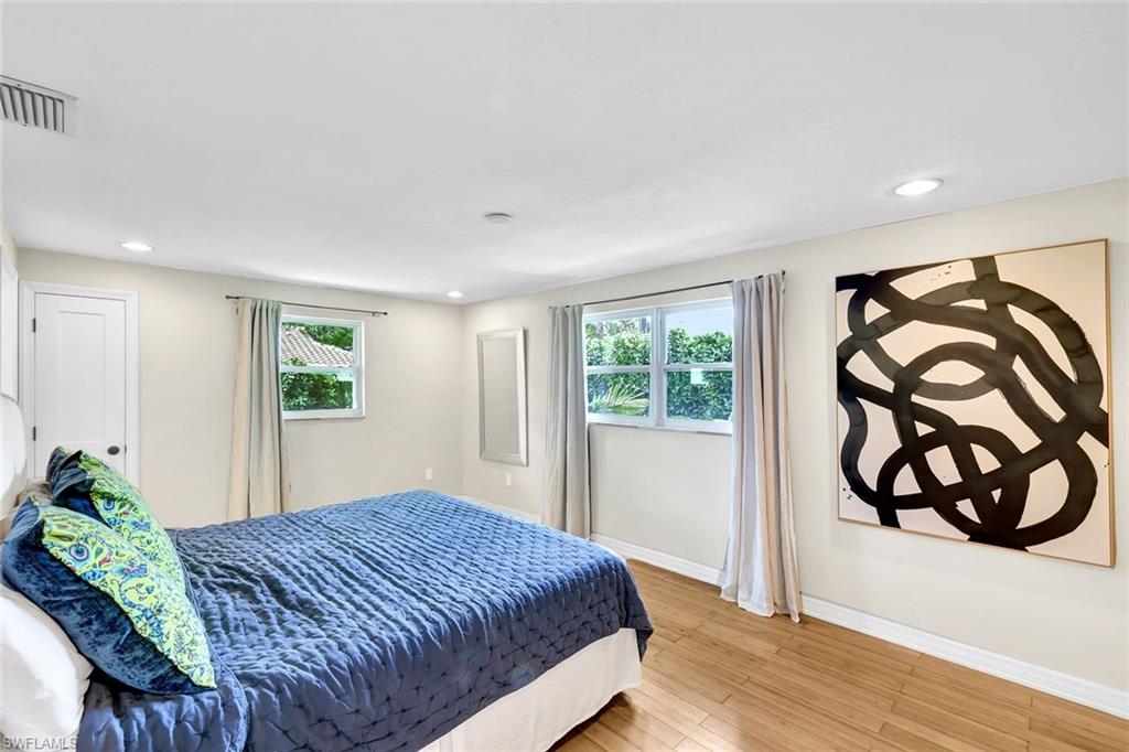 237 Burning Tree Drive Naples, FL 34105 - Photo 13 of 26 a bedroom with a bed and a window
