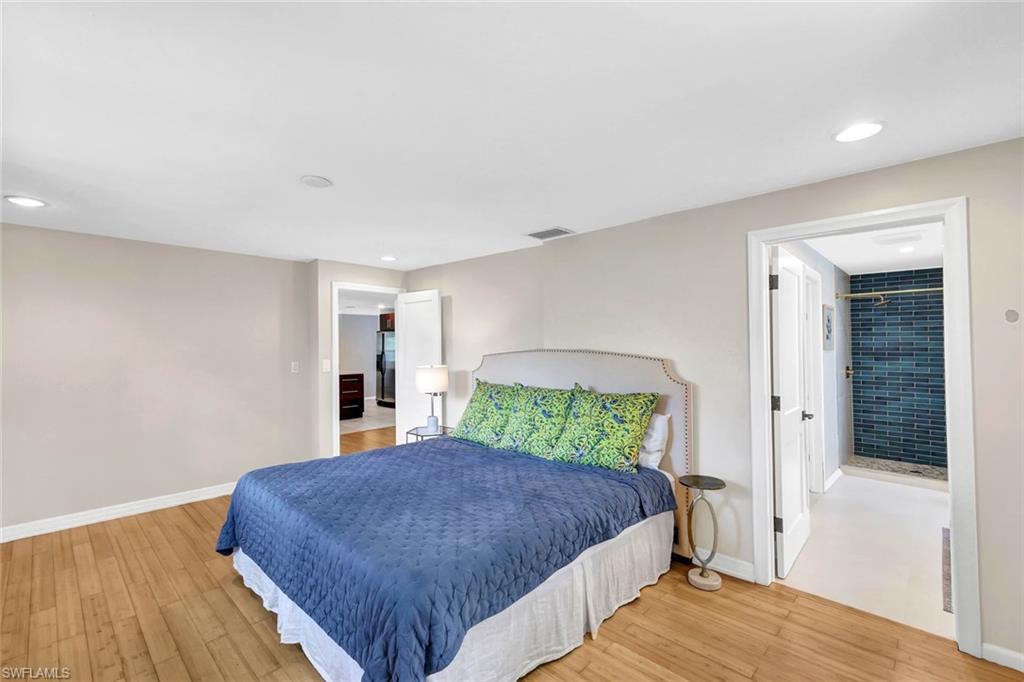 237 Burning Tree Drive Naples, FL 34105 - Photo 14 of 26 a bedroom with a large bed and a window