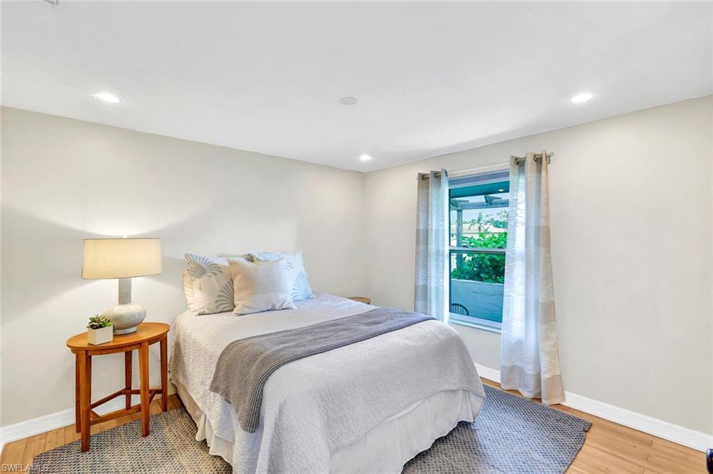 237 Burning Tree Drive Naples, FL 34105 - Photo 18 of 26 a bedroom with a bed and a window