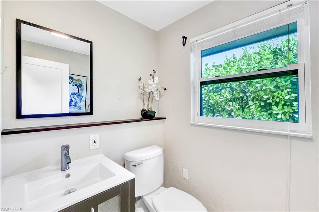 237 Burning Tree Drive Naples, FL 34105 - Photo 19 of 26 a bathroom with a toilet a sink and a window