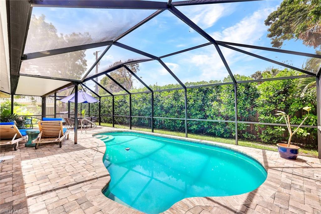 237 Burning Tree Drive Naples, FL 34105 - Photo 20 of 26 a view of a swimming pool with a patio