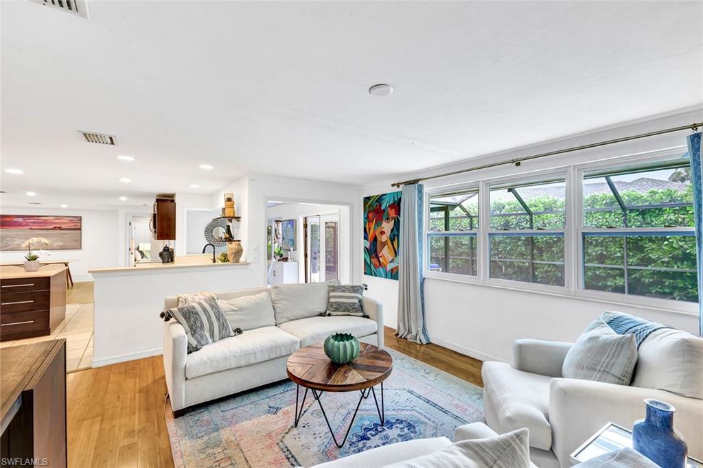 237 Burning Tree Drive Naples, FL 34105 - Photo 2 of 26 a living room with furniture and a large window