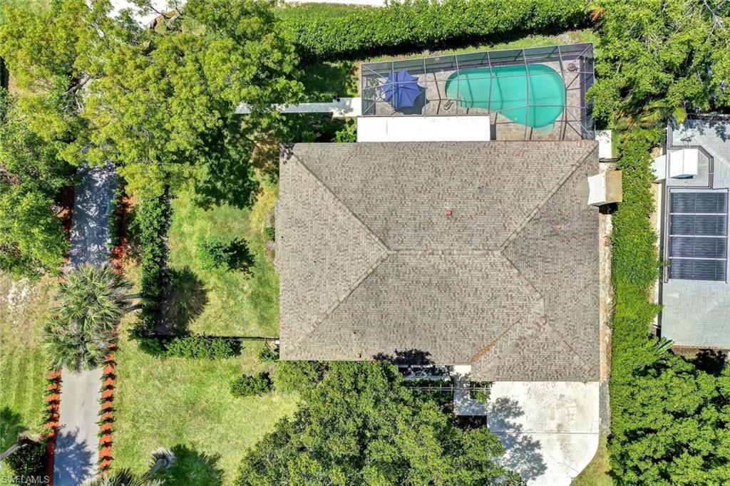 237 Burning Tree Drive Naples, FL 34105 - Photo 23 of 26 front view of a house with a yard