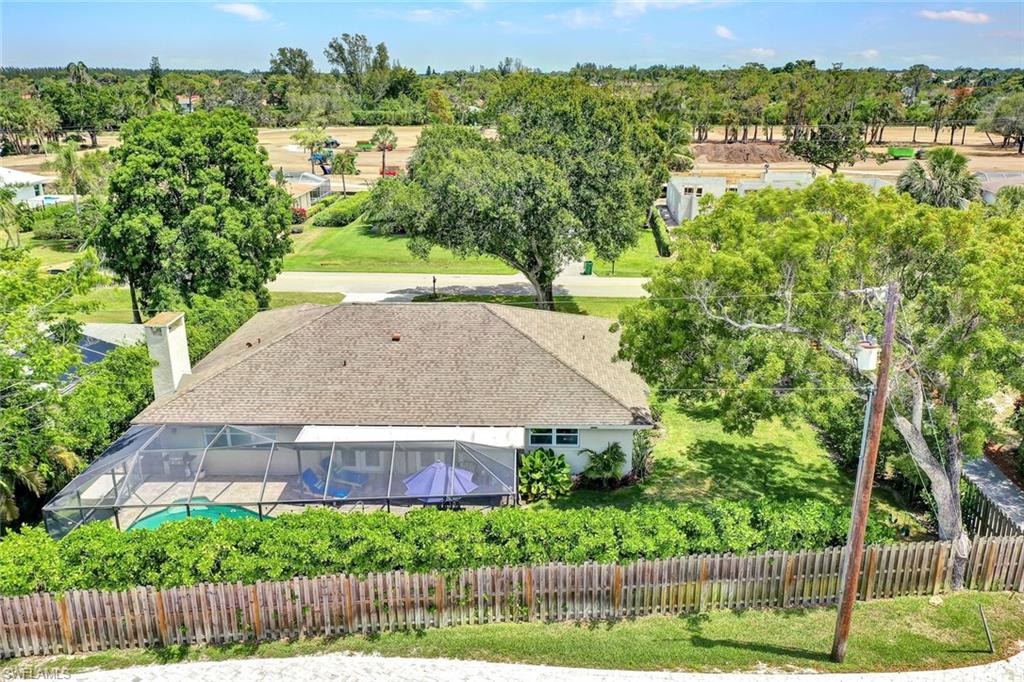 237 Burning Tree Drive Naples, FL 34105 - Photo 25 of 26 an aerial view of a house with a yard and outdoor seating