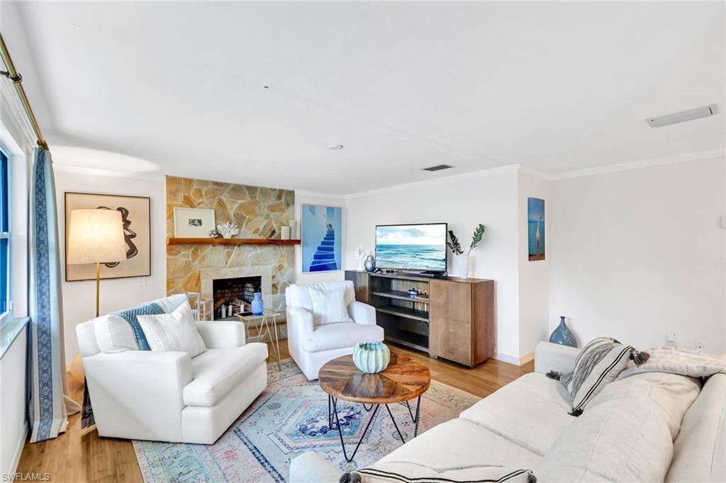237 Burning Tree Drive Naples, FL 34105 - Photo 4 of 26 a living room with furniture and a fireplace