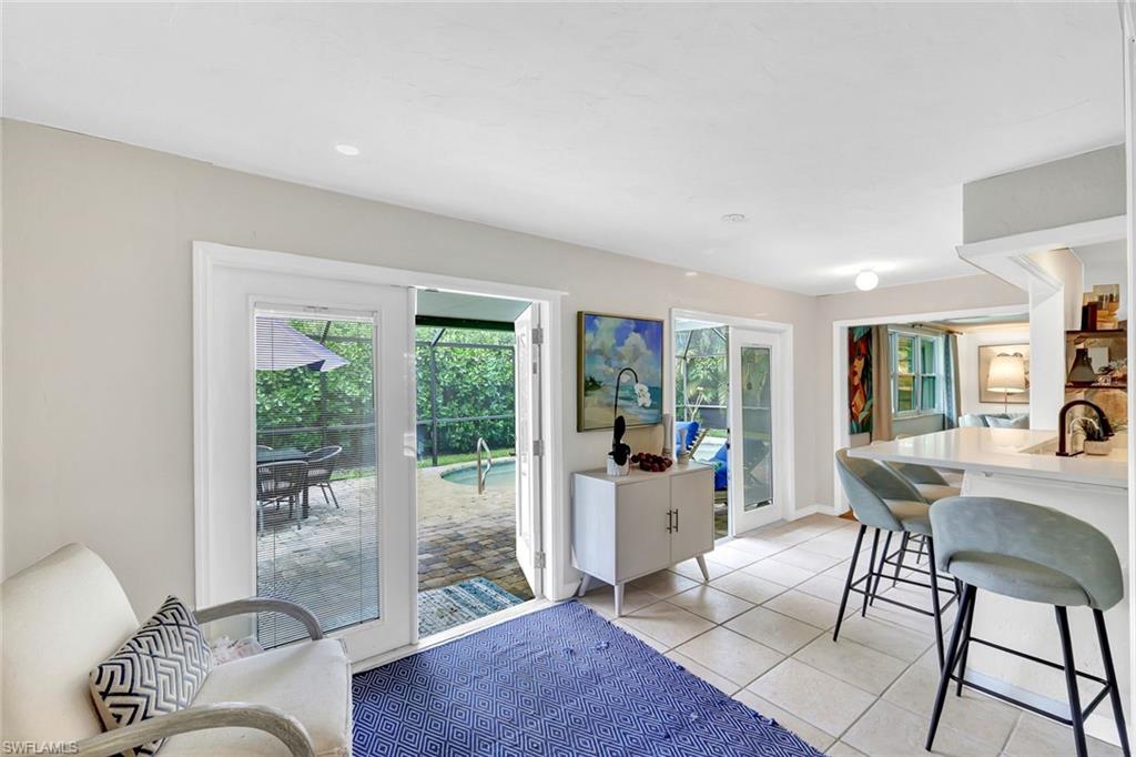 237 Burning Tree Drive Naples, FL 34105 - Photo 9 of 26 a workspace with furniture window and outside view