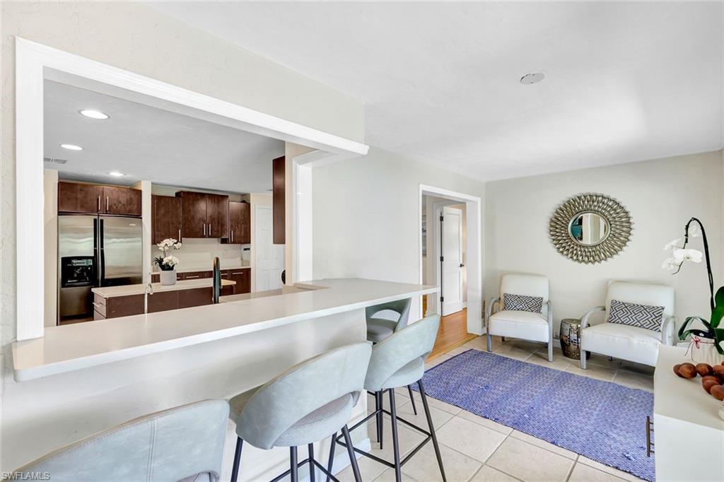 237 Burning Tree Drive Naples, FL 34105 - Photo 10 of 26 a living room with furniture and a flat screen tv