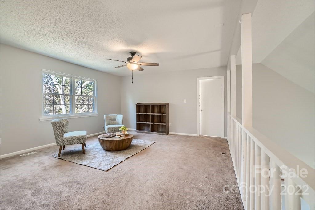 11320 Park Road Charlotte, NC 28226 - Photo 18 of 28 a living room with furniture and a chandelier
