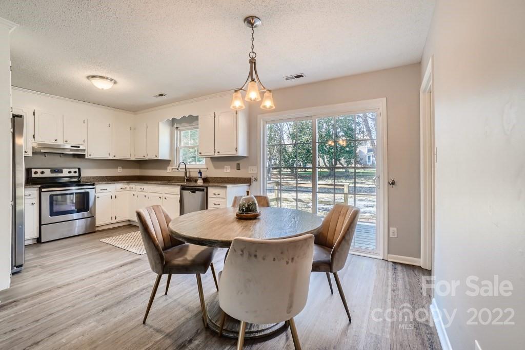 11320 Park Road Charlotte, NC 28226 - Photo 5 of 28 a dining room with furniture window wooden floor