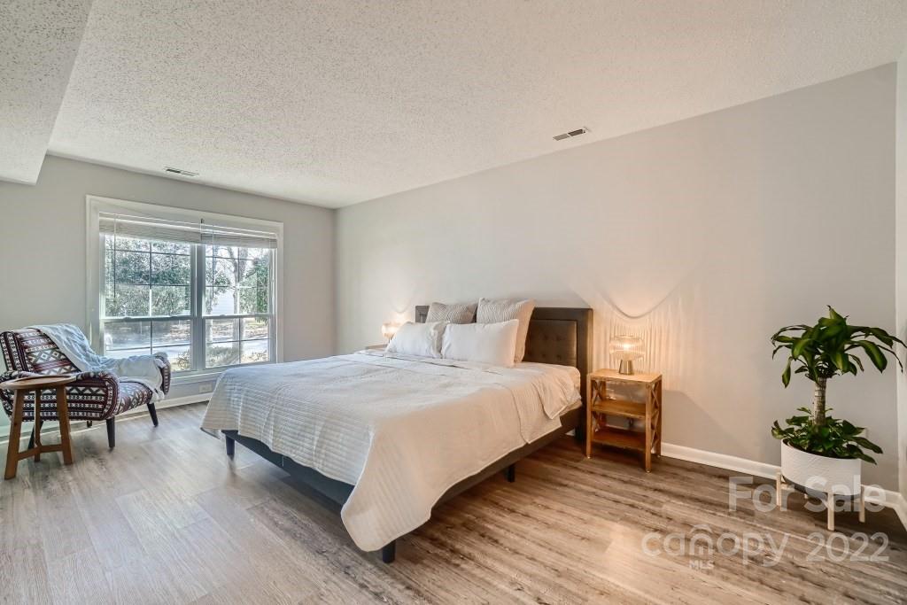 11320 Park Road Charlotte, NC 28226 - Photo 9 of 28 a bedroom with a bed and a chair