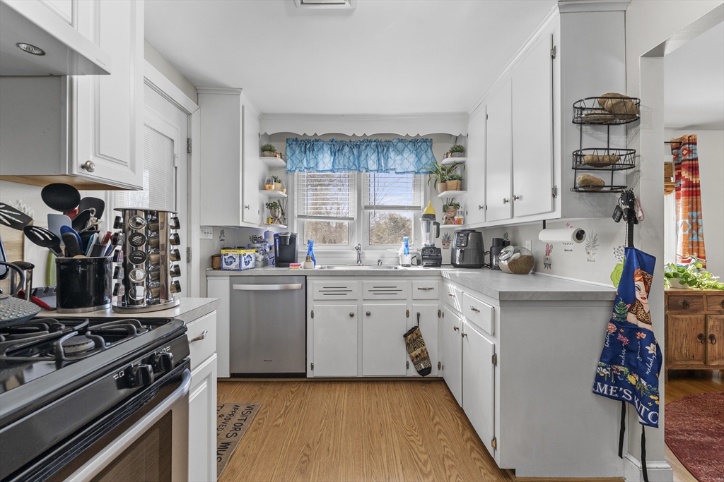 74 Benson Street Whitman, MA 02382 - Photo 12 of 30 a kitchen with a stove a sink and cabinets