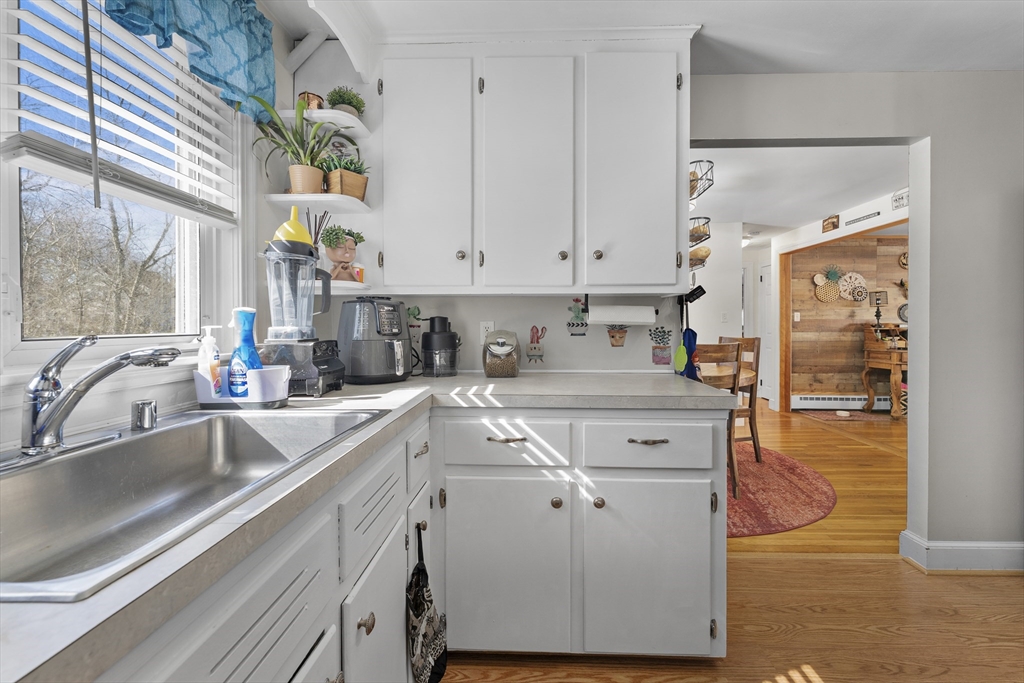 74 Benson Street Whitman, MA 02382 - Photo 14 of 30 a kitchen with stainless steel appliances granite countertop a sink a stove and a refrigerator