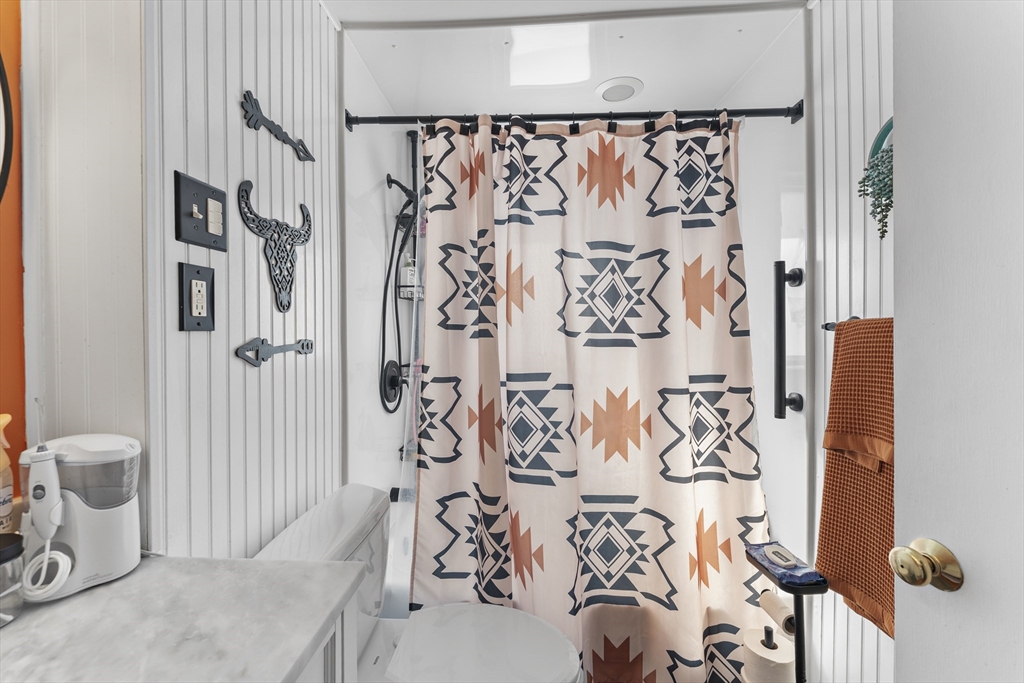 74 Benson Street Whitman, MA 02382 - Photo 17 of 30 a bathroom with a bathtub and shower curtain