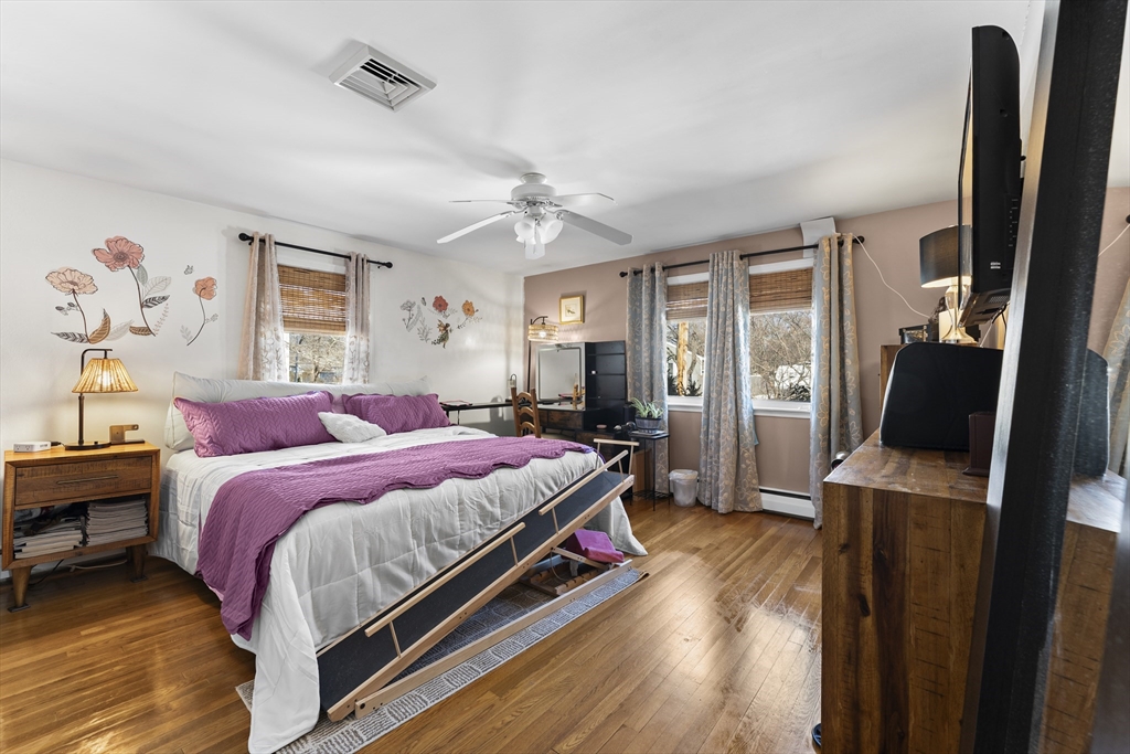 74 Benson Street Whitman, MA 02382 - Photo 19 of 30 a bedroom with a bed and wooden floor