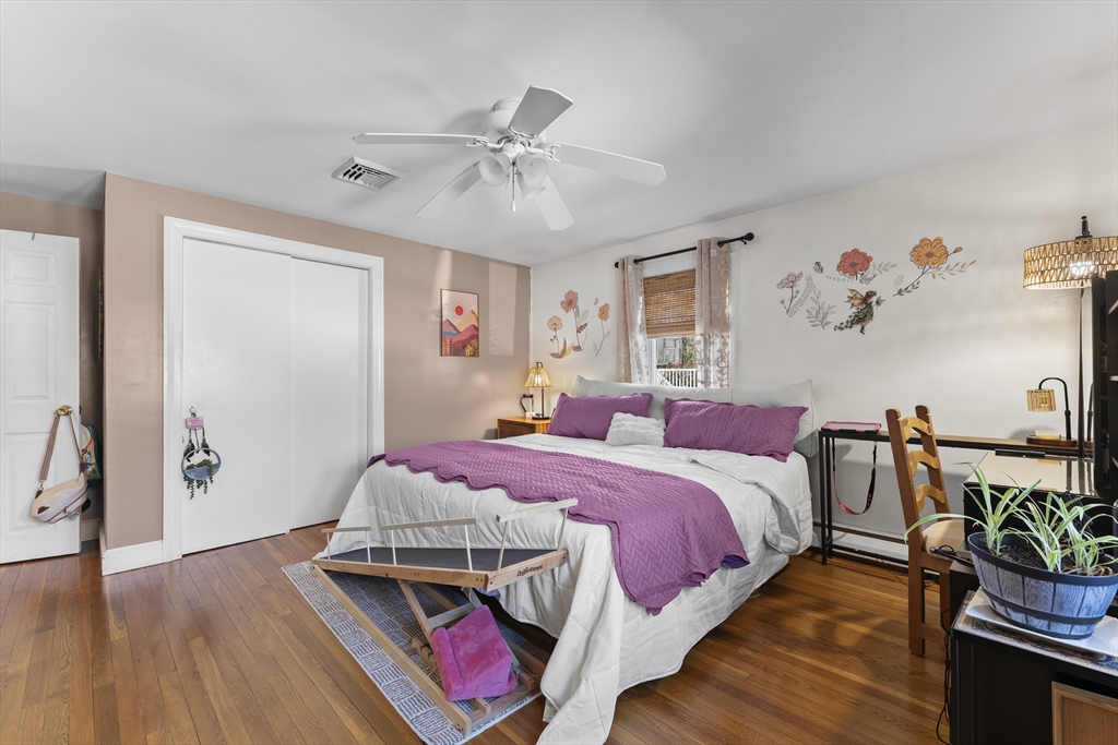 74 Benson Street Whitman, MA 02382 - Photo 20 of 30 a bedroom with a bed and wooden floor