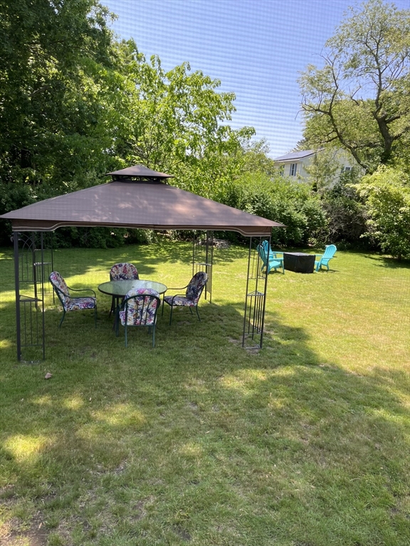 74 Benson Street Whitman, MA 02382 - Photo 2 of 30 a view of swimming pool with lawn chairs under an umbrella