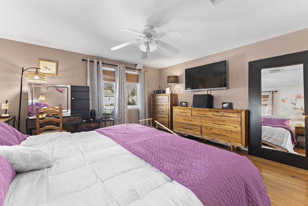 74 Benson Street Whitman, MA 02382 - Photo 21 of 30 a bedroom with a large bed a flat tv screen and a dresser