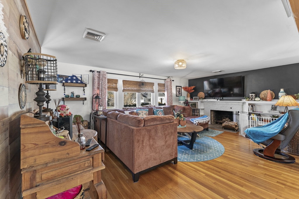 74 Benson Street Whitman, MA 02382 - Photo 5 of 30 a living room with furniture a fireplace and a flat screen tv