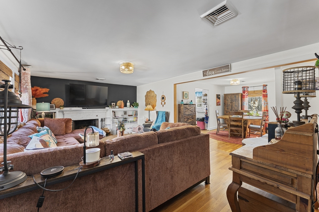 74 Benson Street Whitman, MA 02382 - Photo 8 of 30 a living room with furniture a flat screen tv and a table