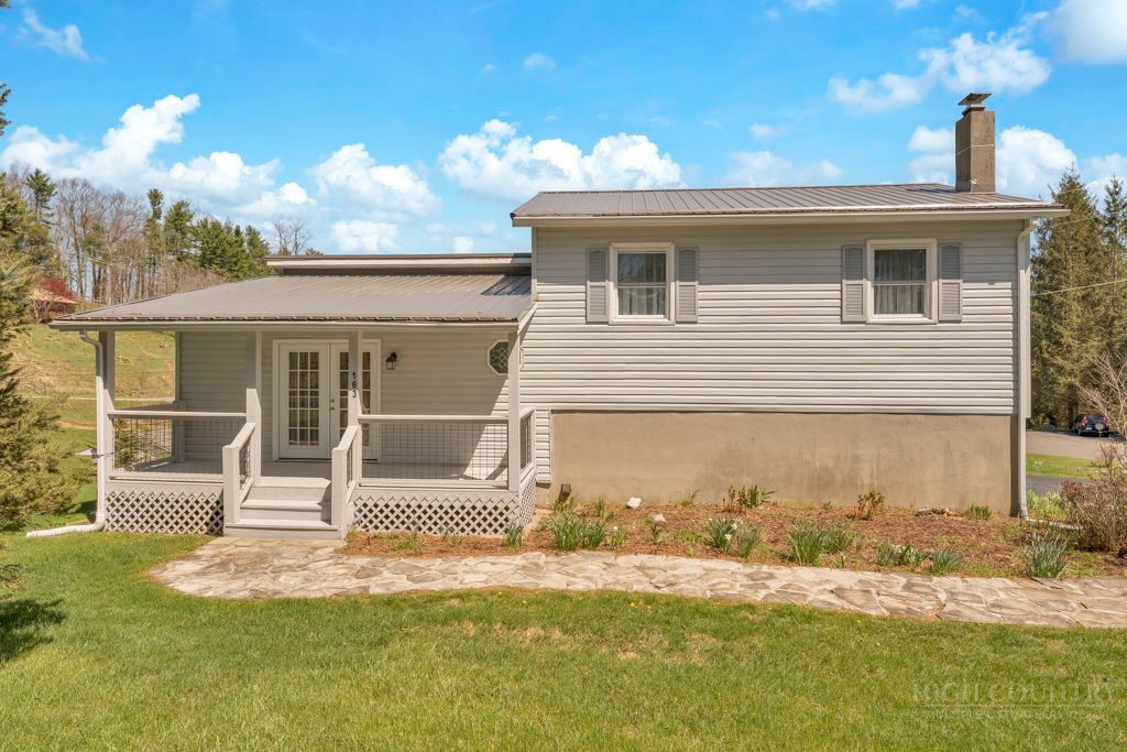 163 Rolling Hill Drive Boone, NC 28607 - Photo 2 of 40 a view of a house with a backyard