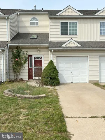a view of a house with a yard and garage