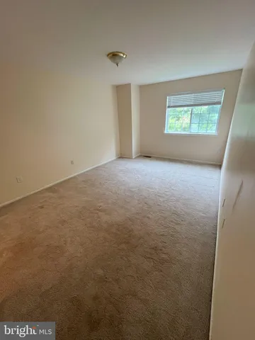 an empty room with a empty space and windows