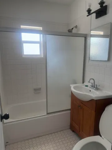a bathroom with a sink toilet and shower