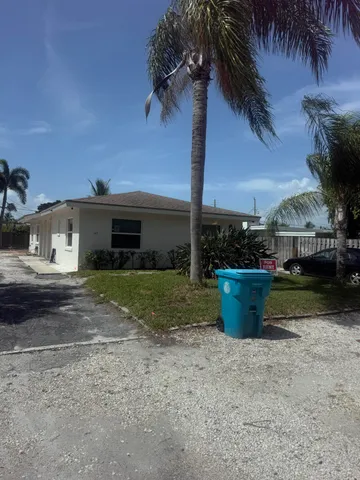 a view of a backyard with potted plants