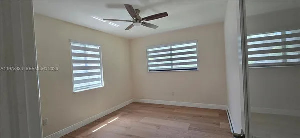 a view of a livingroom with a ceiling fan and window