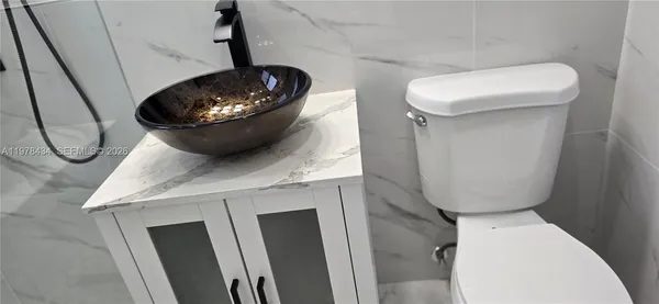 a bathroom with a toilet and a mirror