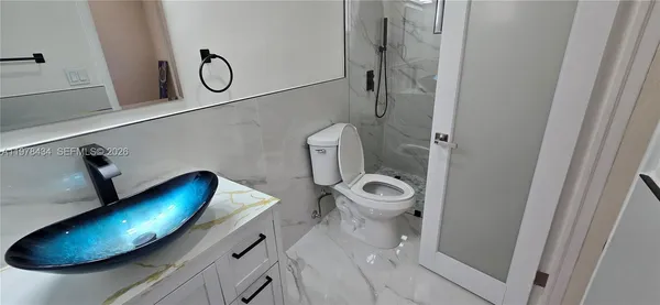 a bathroom with a toilet and a mirror