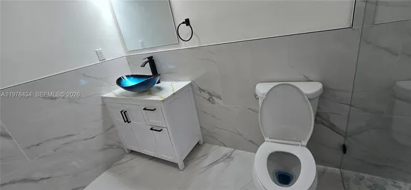 a bathroom with a toilet and a washing machine
