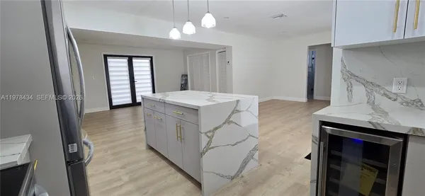 a spacious bathroom with a granite countertop sink a mirror and vanity