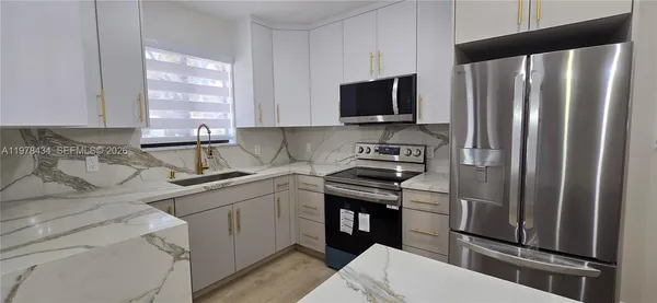 a kitchen with a sink stove and refrigerator