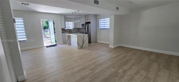 a view of kitchen with furniture and wooden floor