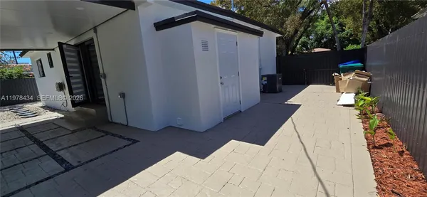 a backyard of a house with outdoor seating