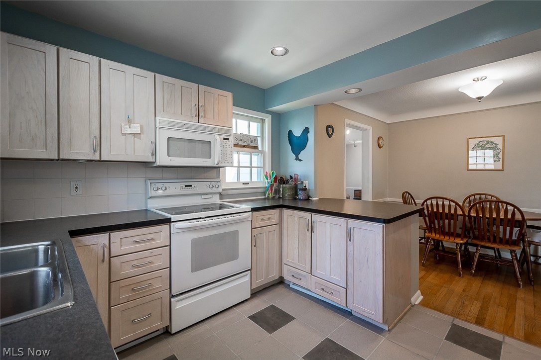 4233 Lambert Road Cleveland, OH 44121 - Photo 5 of 24 Beautifully updated kitchen with counter seating at far right, leading to the dining room.